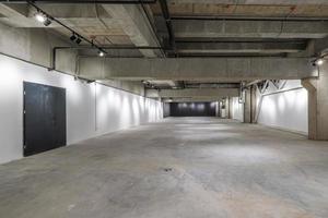 empty interior of large concrete room as warehouse or hangar with spotlights photo