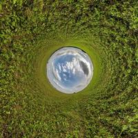 blue sky ball in middle of swirling field. Inversion of tiny planet transformation of spherical panorama 360 degrees. Curvature of space. photo