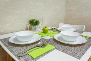 served table with a bouquet of roses in interior of modern luxure guest room in studio apartments in minimalistic style photo