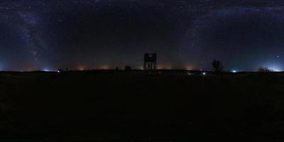 full seamless spherical night panorama 360 degrees angle view on high visibility mountain next to old wooden fire tower and milk way in equirectangular projection, for  VR AR virtual reality content photo