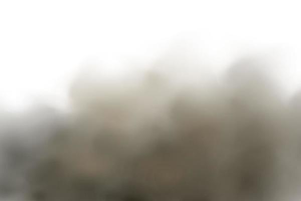 Background of a cloud of brown dust and sand with particles of flying dry sand and dirt.