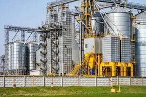 Modern Granary elevator. Silver silos on agro-processing and manufacturing plant for processing drying cleaning and storage of agricultural products, flour, cereals and grain. seed cleaning line photo