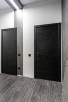 black wooden door in dark style color for modern interior and apartments flat or office photo