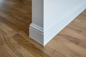 Detail of corner flooring with intricate crown molding and plinth. photo