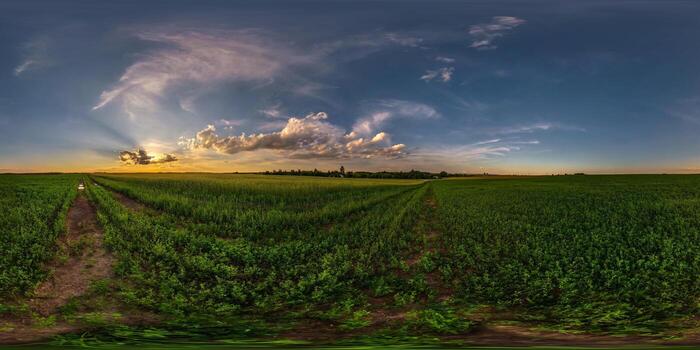 spherical evening hdri panorama 360 view among farming fields with awesome sunset clouds in equirectangular projection, ready for VR AR virtual reality content photo