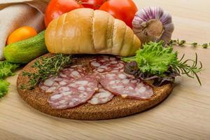 Salami on wooden plate photo