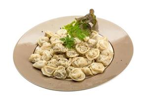 Russian dumplings on the plate and white background photo