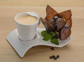 Coffee with muffin on wooden background photo