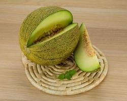 Melon on wooden background photo