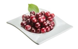 Cherry in the bowl on white background photo