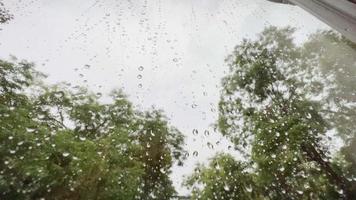 View through glass, rainy weather, raindrops on glass.