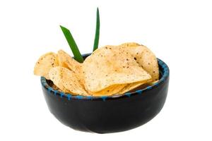 Potato chips in a bowl on white background photo