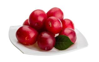 Damson plum on the plate and white background photo