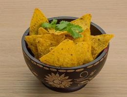 Nachos in a bowl on wooden background photo