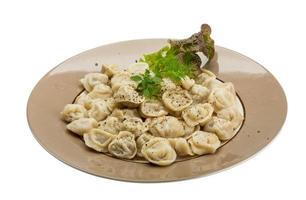 Russian dumplings on the plate and white background photo