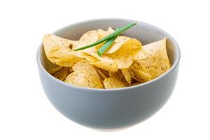 Potato chips in a bowl on white background photo
