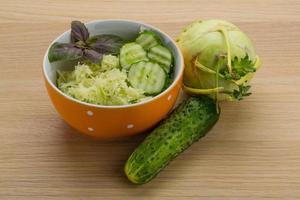 Kohlrabi salad on wooden background photo