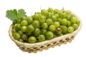 Gooseberry in a basket on white background photo