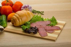 Salami sausages on wooden plate photo