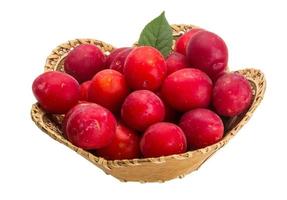 Damson plum in a basket on white background photo