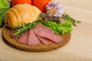 Salami on wooden plate photo