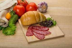 Salami on wooden plate photo