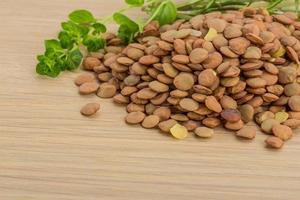 Raw lentils on wooden background photo