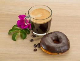 Chocolate donuts on wooden background photo