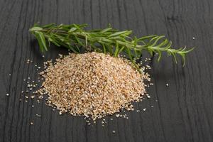 Crusted pearl barley on wooden background photo