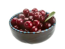 Cherry in the bowl on white background photo
