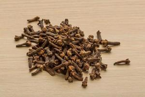 Clove seeds on wooden background photo