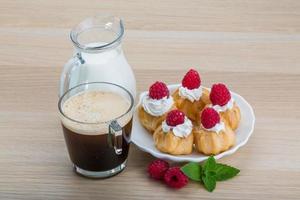 Profiterole with raspberry photo