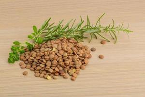 Raw lentils on wooden background photo