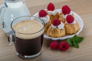 Profiterole with raspberry photo