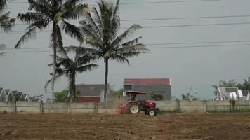 a farmer plows his dry field in summer video