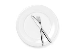 Empty plate with knife and fork isolated on a white background. photo