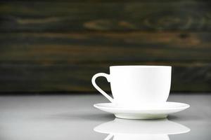 Coffee cup on table with wood background photo