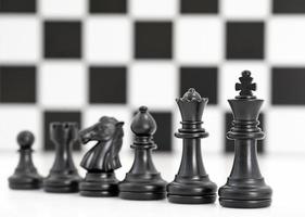 Set of Black chess pieces on white background photo