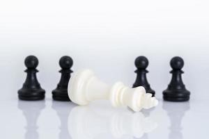 Black and white chess pieces on white background photo