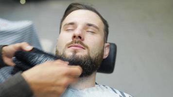 Barber dried client's beard with towel video