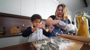 jovem e mulher adulta na cozinha fazendo biscoitos