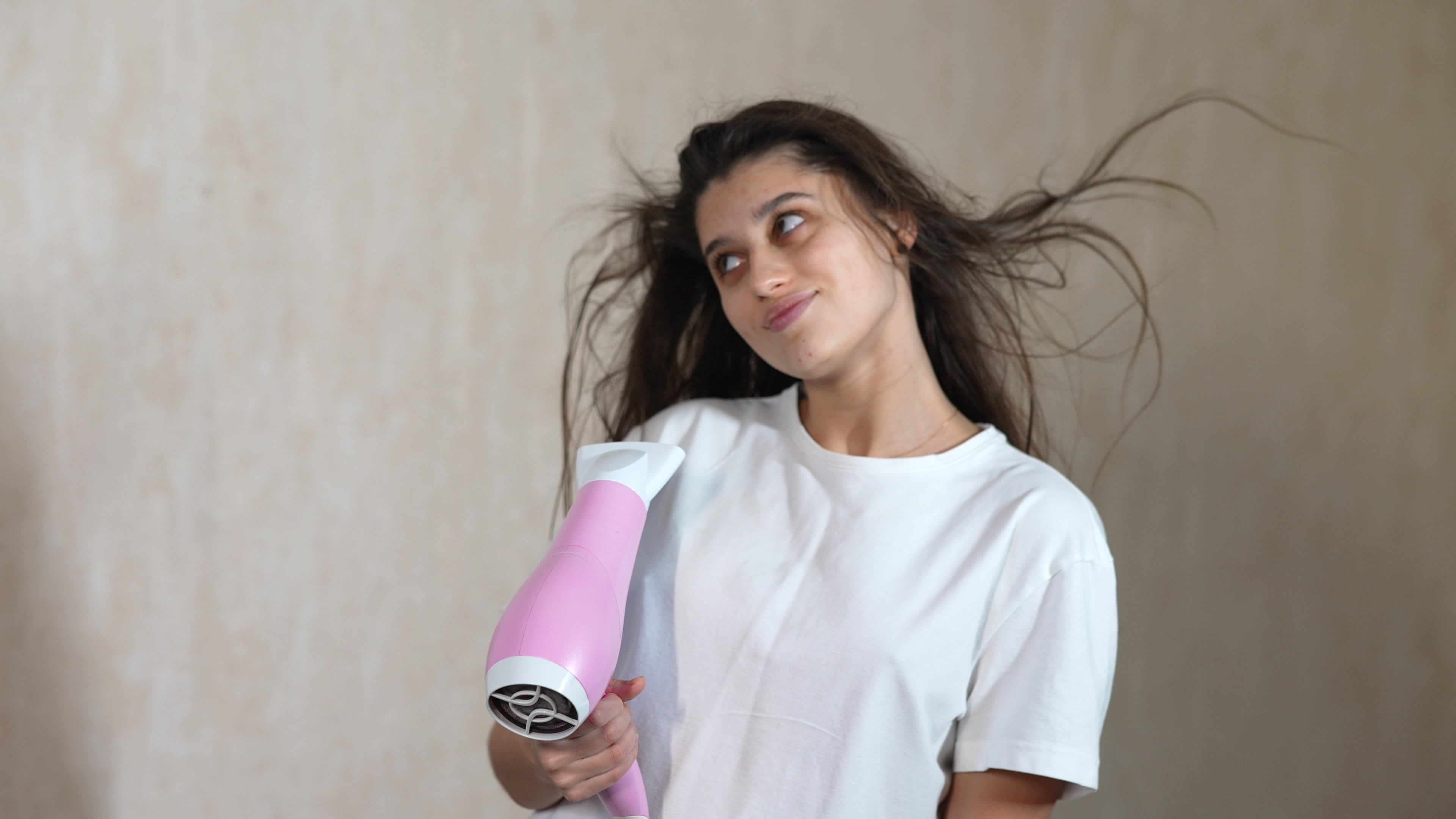 Woman blow drying hair making eye contact and blows a kiss 10941004 Stock Video at Vecteezy
