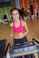 woman exercising on treadmill in gym photo