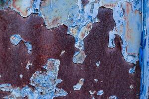 Corroded blue metal background. metal background with streaks of rust. rusted surface with crack and stains. photo