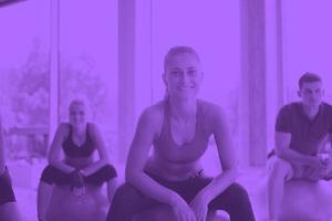 group of people exercise with balls on yoga class photo
