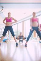 group of  people working out in a fitness gym photo