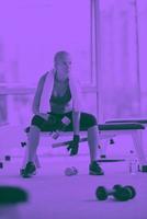 young woman exercise with dumbells photo