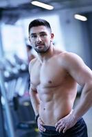 handsome man exercising at the gym photo