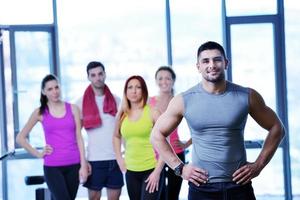 Group of people exercising at the gym photo