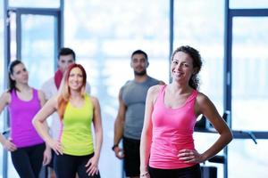 Group of people exercising at the gym photo